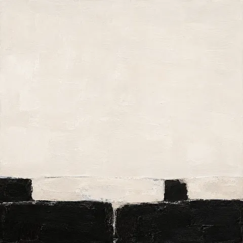 A stone wall coping with two courses in cream, black, white; square artwork.