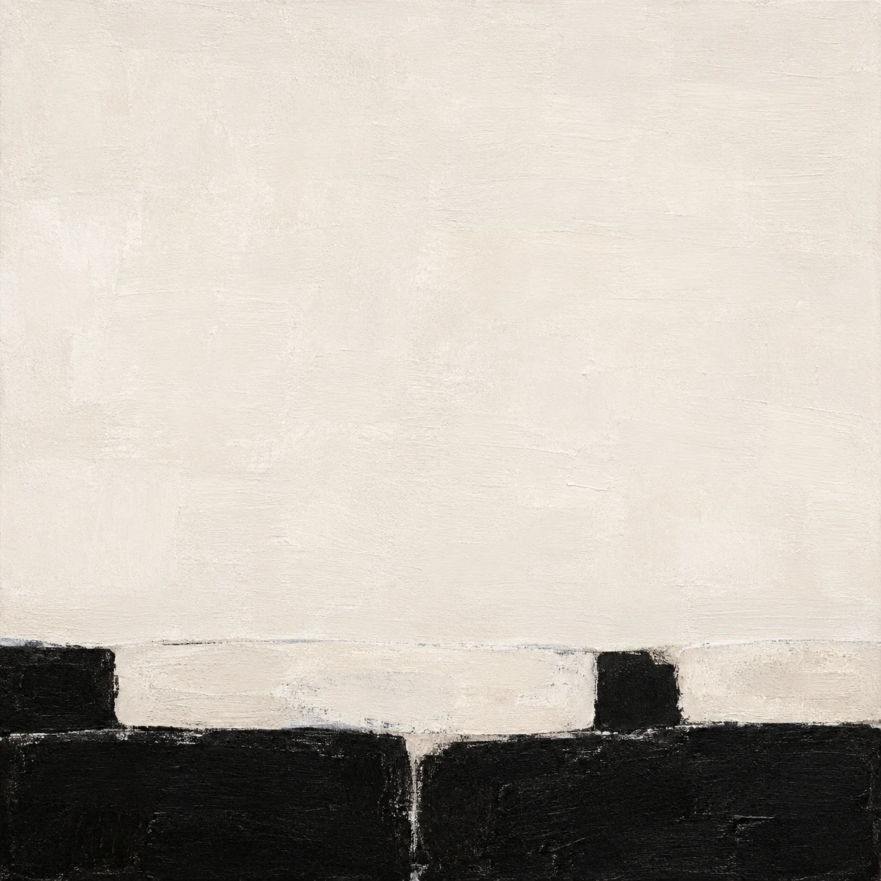 A stone wall coping with two courses in cream, black, white; square artwork.