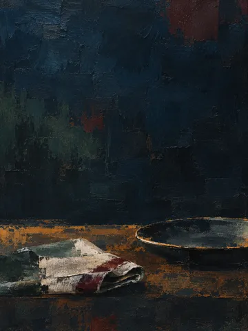 A folded linen napkin and a plate in black, brown; portrait artwork.