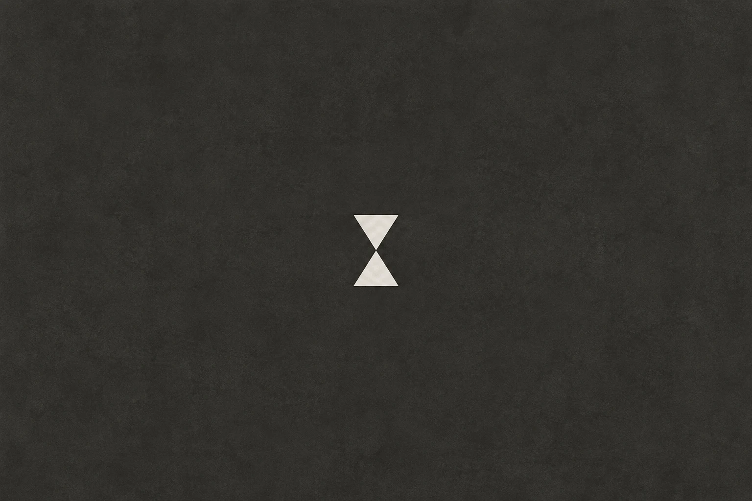 An hourglass of two soft triangles in charcoal; landscape artwork.