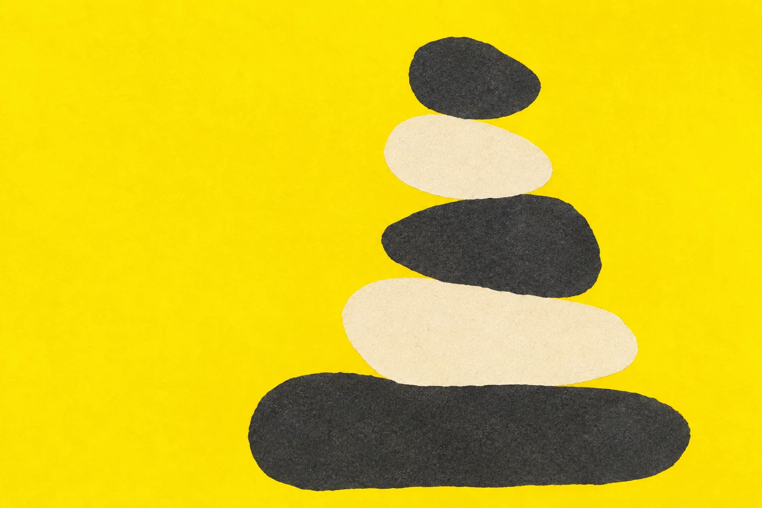 Stacked rounded stones of uneven size in yellow, charcoal, cream; landscape artwork.