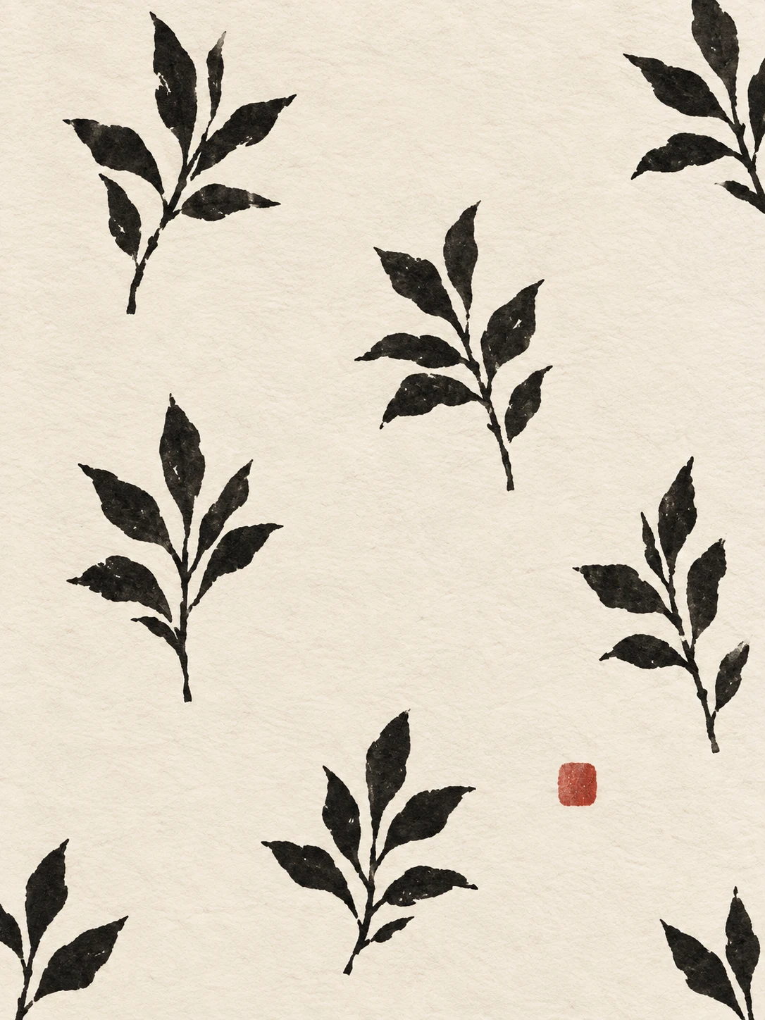 A hand-blocked repeat of small leaves, imperfect registration in cream, charcoal, white; portrait artwork.