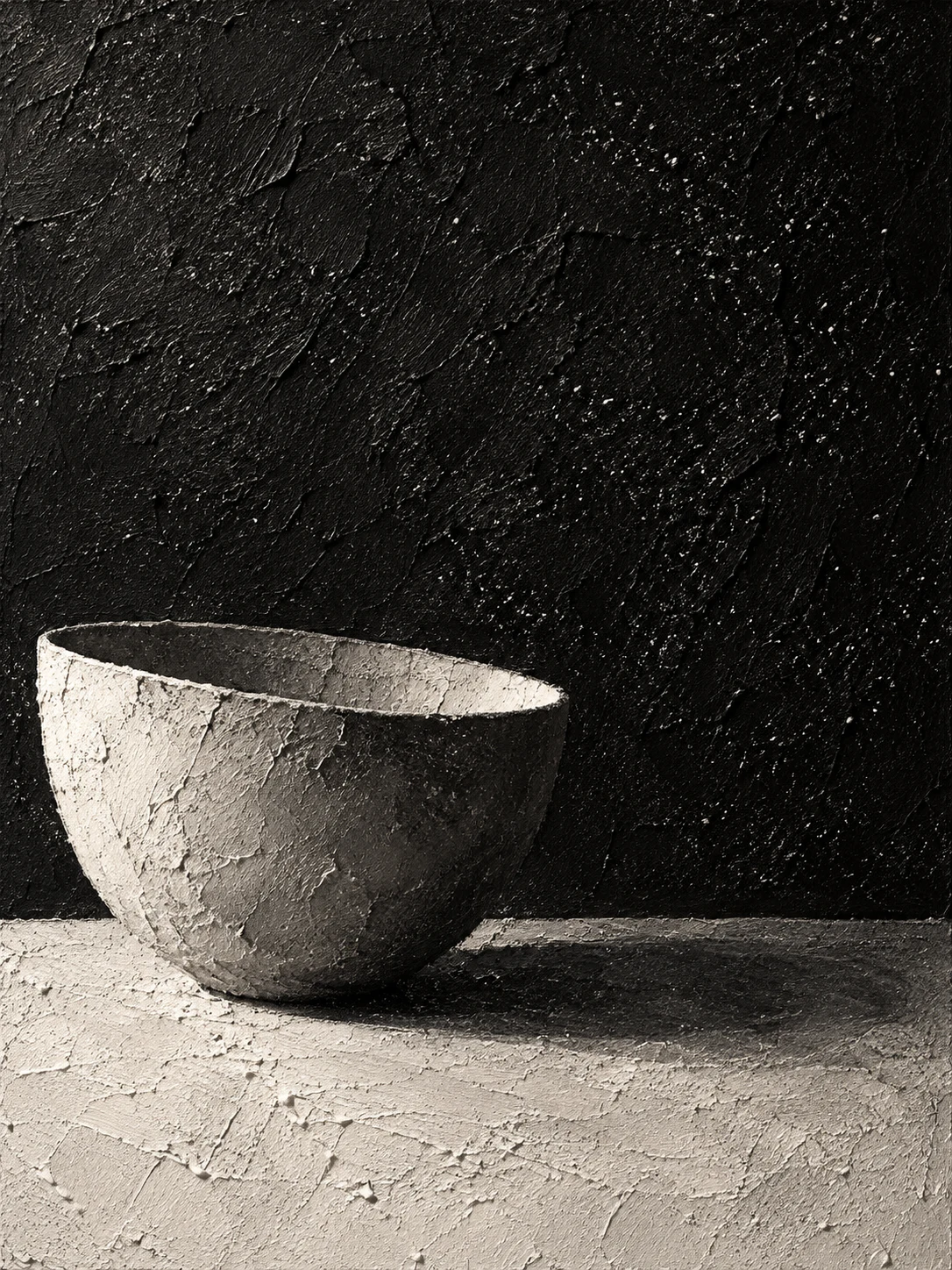 A single bowl on a plain table in black, cream, sand, charcoal; portrait artwork.