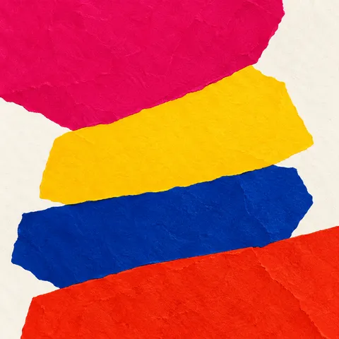 A tower of stacked paper slabs in red, yellow, navy, white; square artwork.