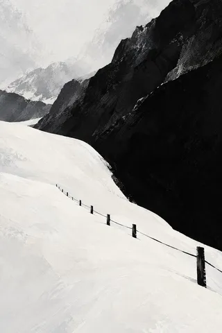 A snowfield with one dark fence line in cream, black, white, stone; portrait artwork.
